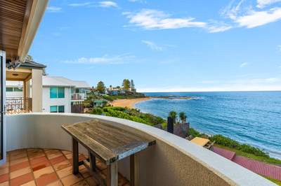 Covered balcony with panoramic Blue Bay ocean views